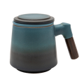 A blue ceramic tea infuser cup with a removable lid and a wooden handle.