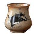 Brown ceramic teacup with a hand painted black cat.