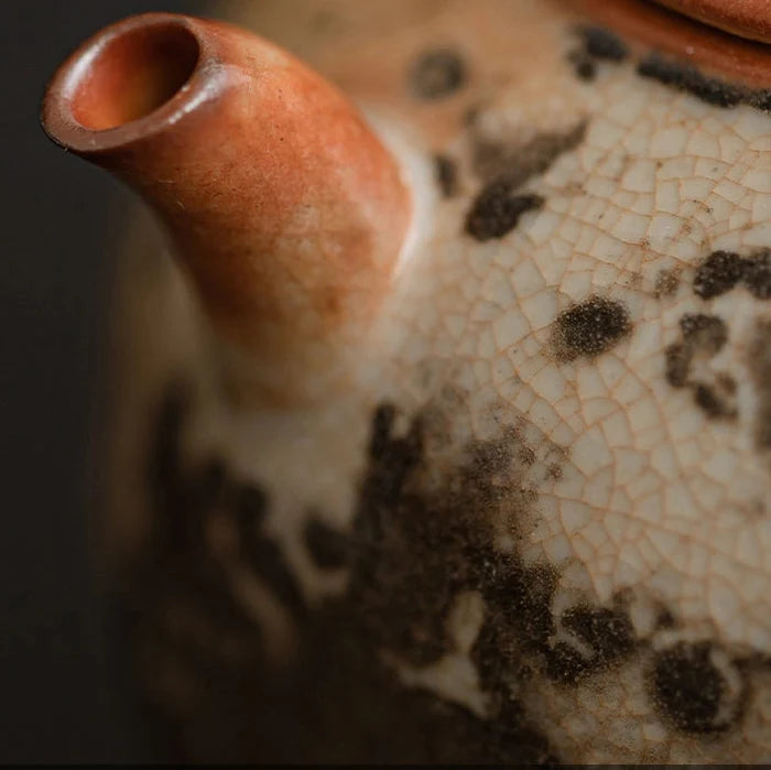Close-up of a ceramic teapot with a cracked glaze pattern