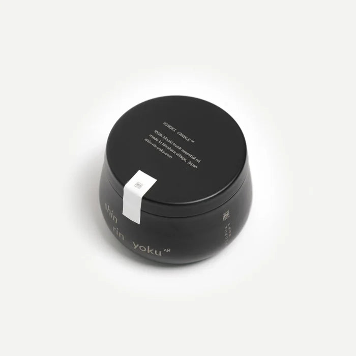 Black cosmetic jar with white label on a white background