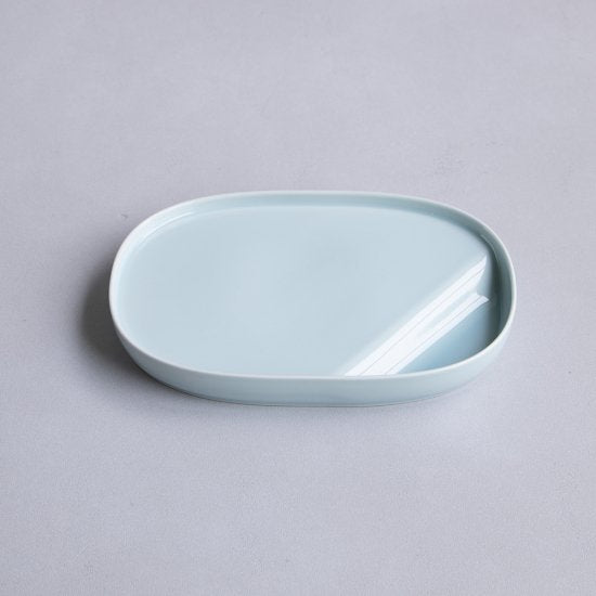 Light blue ceramic dish on a gray background