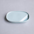 Light blue ceramic dish on a gray background