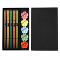 Black box of a color chopstick set with chopstick floral rests.