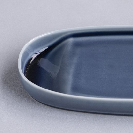 Blue ceramic tray on a light gray background