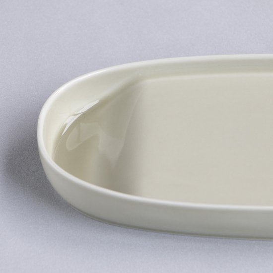 Beige ceramic dish on a light gray background