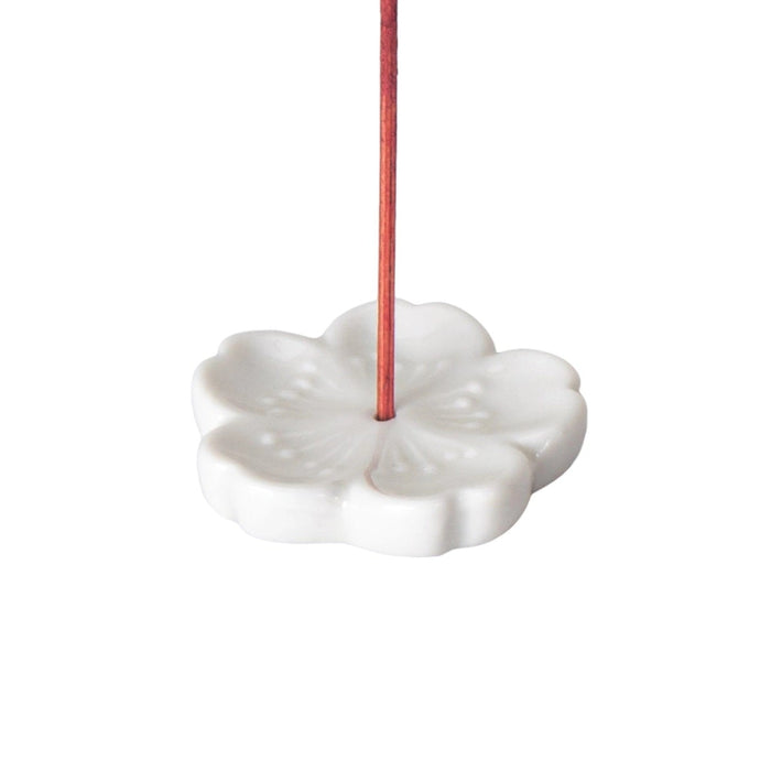Sakura flower incense holder in white on a white background.