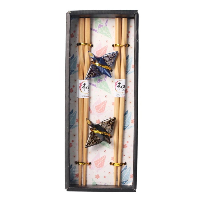 Set of chopsticks with decorative ends in a box with a decorative pattern.