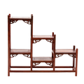 A traditional Japanese ornate rosewood shelf with scroll detailing and a stagnated 'step' design.