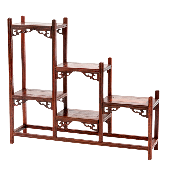 A traditional Japanese ornate rosewood shelf with scroll detailing and a stagnated 'step' design.