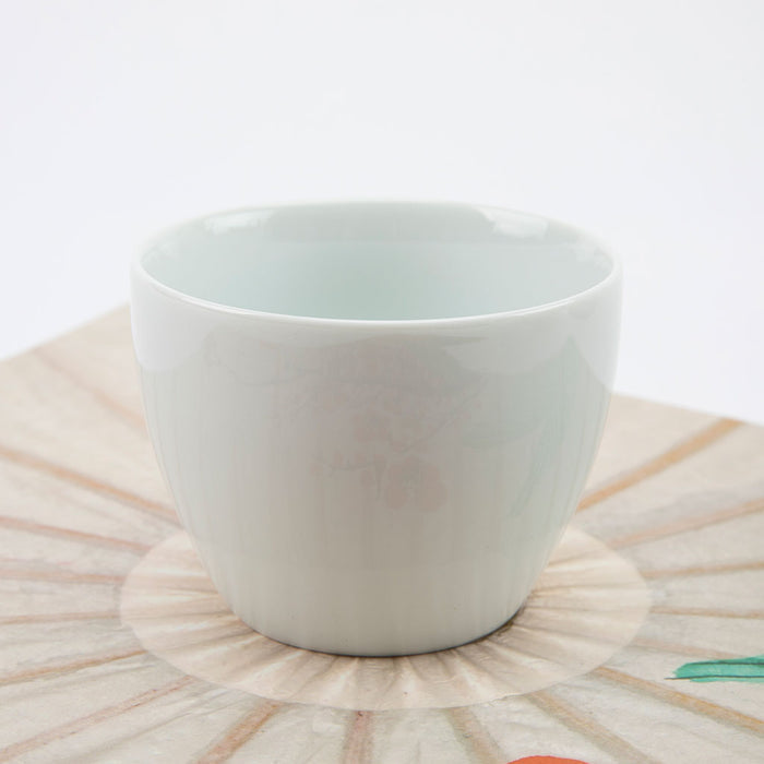 White ceramic bowl on a decorative plate with a white background
