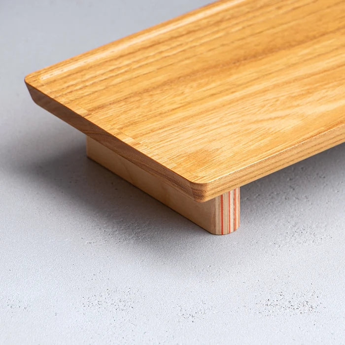 Wooden cutting board on a light gray surface
