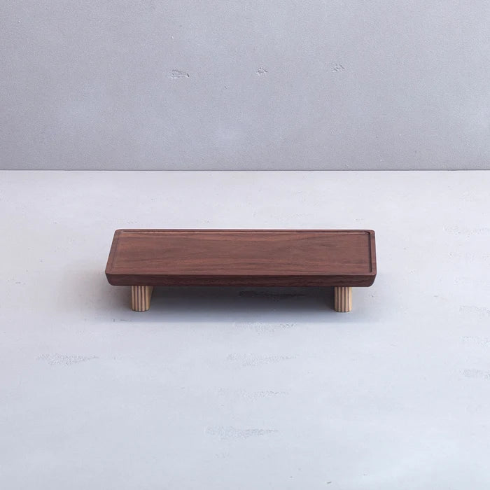 Wooden footstool with four legs on a white background