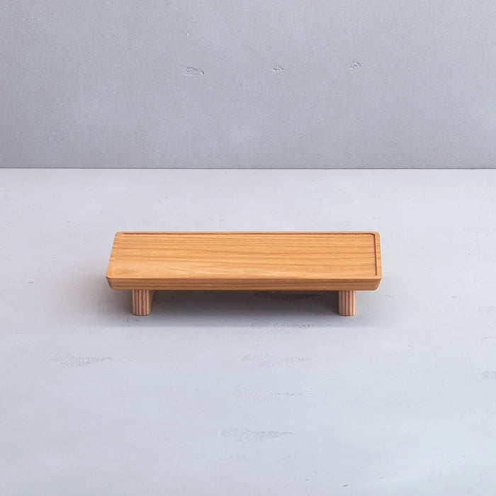 Wooden bench on a light gray background