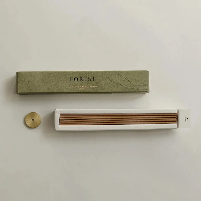 Incense set with 'FOREST' packaging on a light background