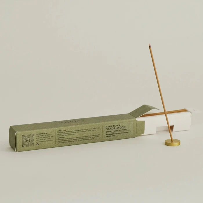 Incense stick with packaging on a light gray background