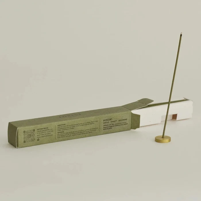 Incense stick and packaging on a light gray background