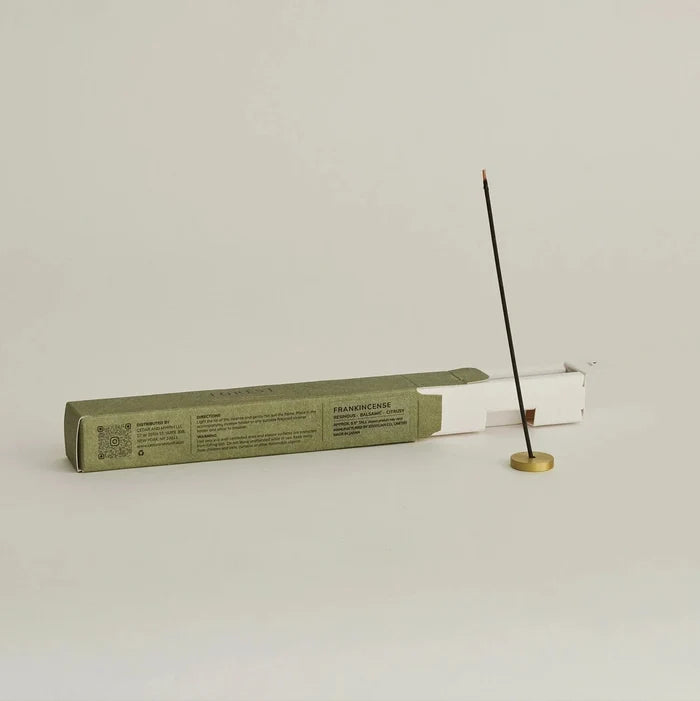 Incense stick and packaging on a light gray background