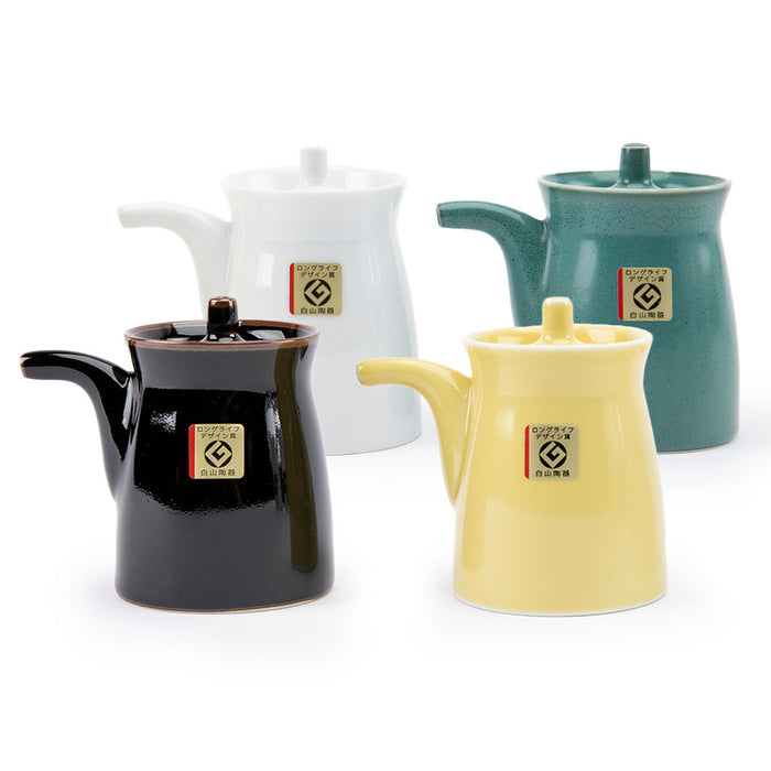 Four soy sauce dispensers on a white background