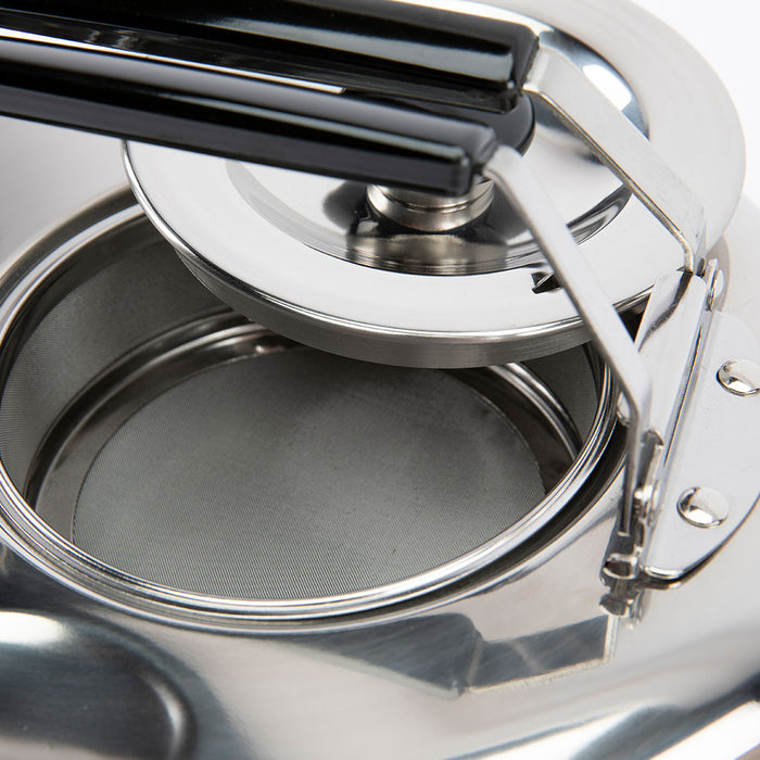 Close-up of a silver teapot with open lid