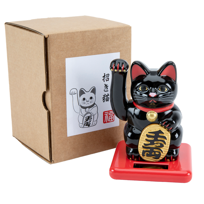 A black and gold colored solar-powered waving cat figurine, Maneki Neko, next to its packaging box with a illustration of the cat.